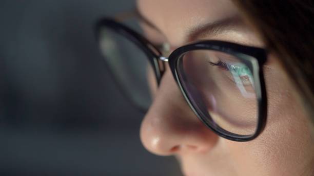 istock Young woman in glasses uses computer, tablet, smartphone. Reflection of display 1371555596
