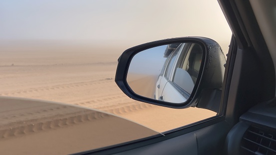 POV car driving on asphalt highway. Left side traffic. Desert road in Africa. Fog misty weather. Journey in Namibia. Danger drive slow. Gravel dirt road.
