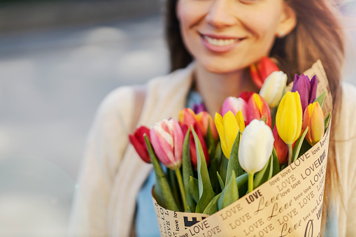 Close up of a bouquet of tulips woman is holding on international women's day.