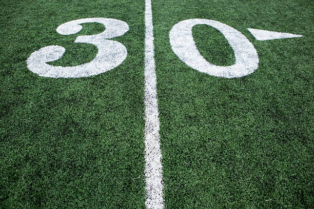 istock Football stadium 30 yard line artificial grass markings 137156077