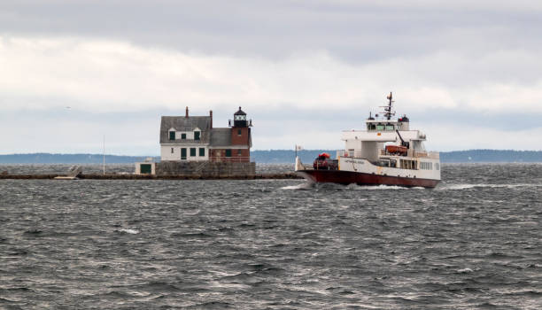 Rockland Breakwater Lighthouse with Captain Neal Burgess Ferry Passing By stock photo