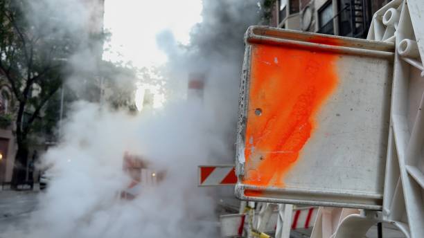 istock Smoke or steam from the heating system. Pipe for pressure release 1371562246
