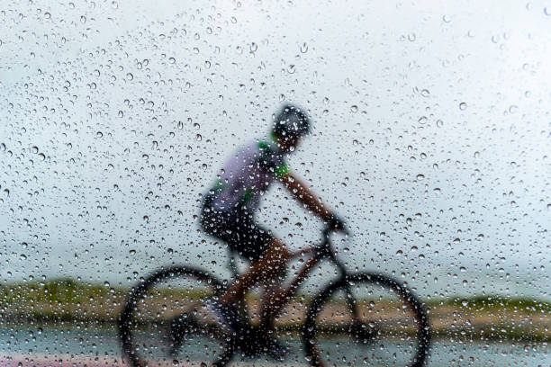 istock A person riding a bicycle in the rain. 1371564228