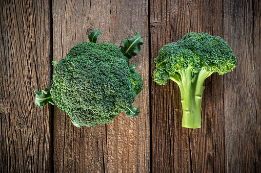 Broccoli crucifer raw vegetable closeup on rustic wood board table background leaving copy space