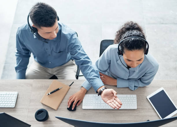 istock High angle shot of two call centre agents working together on a computer in an office 1371565435