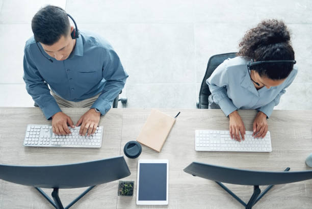 istock High angle shot of two call centre agents working on computers in an office 1371565444