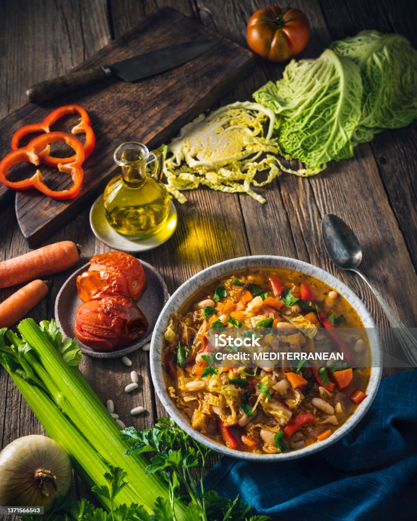 Vegetable Cabbage Soup vegan ingredients celery, beans, bell pepper, carrots, parsley and tomatoes Vegetable Cabbage Soup vegan ingredients as celery, beans, bell pepper, carrots, parsley and roasted tomatoes. Healthy and delicious winter soup, we can switch cabbage for any other crucifer vegetables, plant based diet. Stew Stock Photo