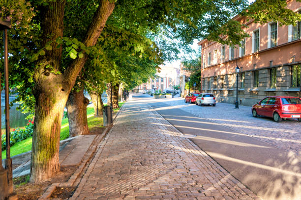 Sunshine on the trees, sidewalks and historic buildings of Linnankatu in Turku, Finland.