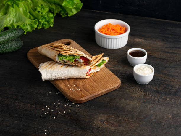 istock Burrito wraps with chicken and vegetables on a cutting board. Mexican shawarma 1371568150