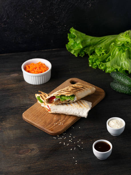 istock Burrito wraps with chicken and vegetables on a cutting board. Mexican shawarma 1371568296