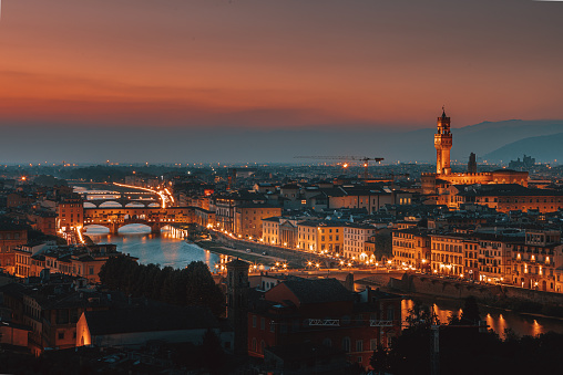 Aerial and panoramic view of Arno River, Duomo Cathedral and Ponte Vecchio and cityscape during a beautiful sunset, Florence, Italy. High Resolution. XXL