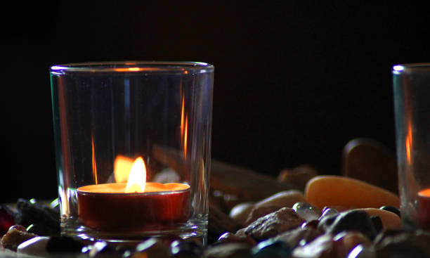 istock Candles in glass glasses surrounded by stones 1371573630