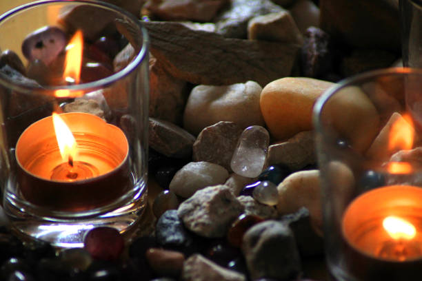 istock Candles in glass glasses surrounded by stones 1371573632