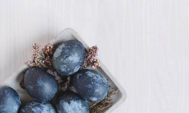 istock blue easter eggs in eco style on gray plate on  white wooden table and dried flowers, easter background with eggs top view 1371573913