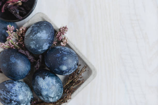 istock blue easter eggs in eco style on gray plate on white wooden table and dried flowers, easter background with eggs top view 1371573916