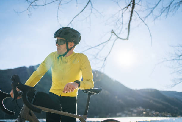 rowerzysta drogowy relaksuje się na plaży nad jeziorem lugano - racing bicycle bicycle cycling yellow zdjęcia i obrazy z banku zdjęć