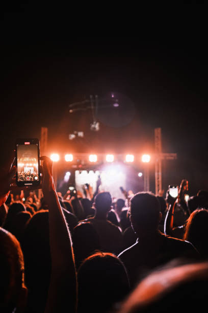 音楽コンサートを見ているファンの好奇心旺盛な群衆 - nightlife popular music concert entertainment crowd ストックフォトと画像