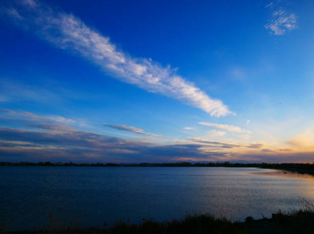 istock Cloudy landscape with a blue sky over the pond 1371581848