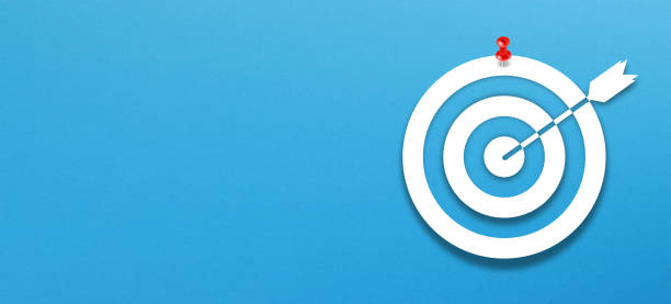 istock Target sign with red pin on blue background 1371585623