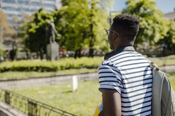 istock Back view of young man walking 1371586297