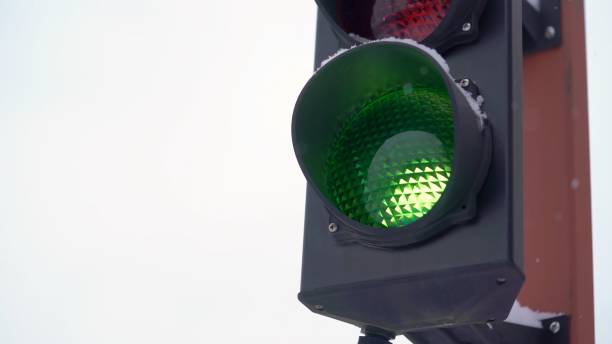 istock Traffic lights. Green flashing traffic signal. Winter, snow, snowfall 1371586310