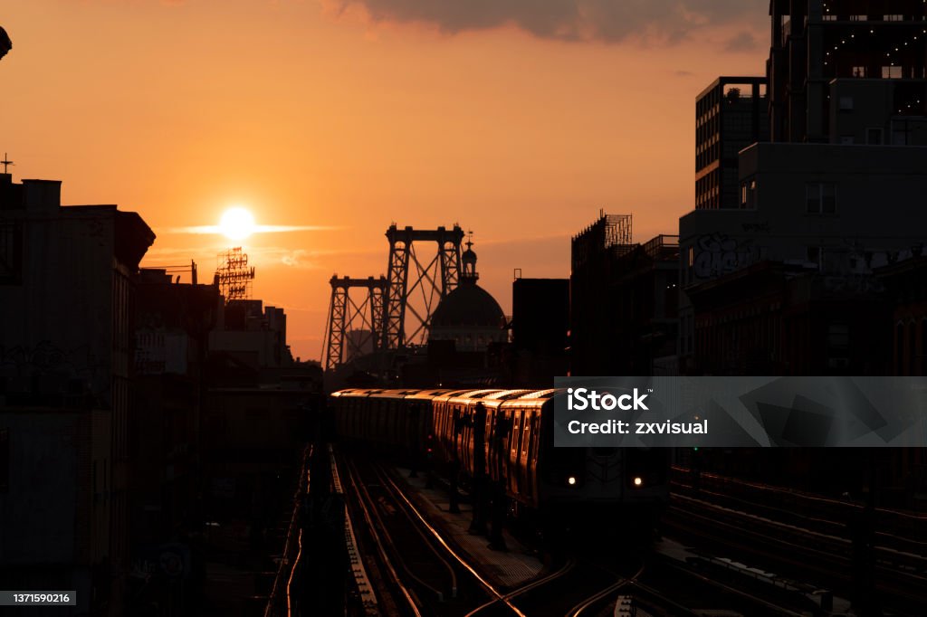 Sunset Subway Train Subway train at sunset in Williamsburg, Brooklyn. Bridge - Built Structure Stock Photo