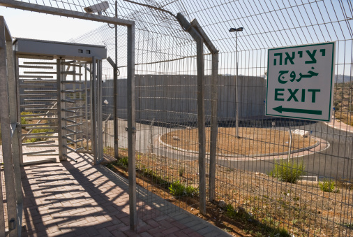 Part of an Israeli checkpoint at the entrance to Bethlehem.  Bethlehem lies behind the 24-foot-high concrete wall, seen here in the background.  A roundabout (also in background) is now located on what was once the main road into Bethlehem from Jerusalem.