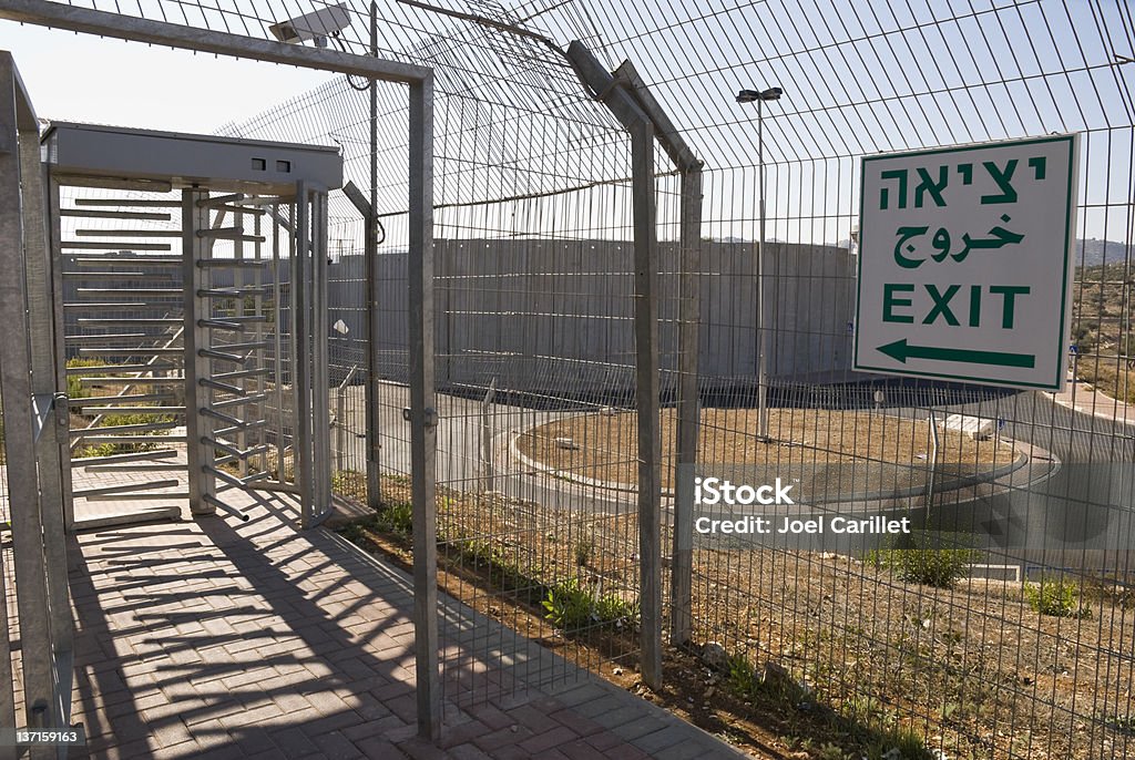 Turnstile at Bethlehem checkpoint in the West Bank Part of an Israeli checkpoint at the entrance to Bethlehem.  Bethlehem lies behind the 24-foot-high concrete wall, seen here in the background.  A roundabout (also in background) is now located on what was once the main road into Bethlehem from Jerusalem. Surrounding Wall Stock Photo