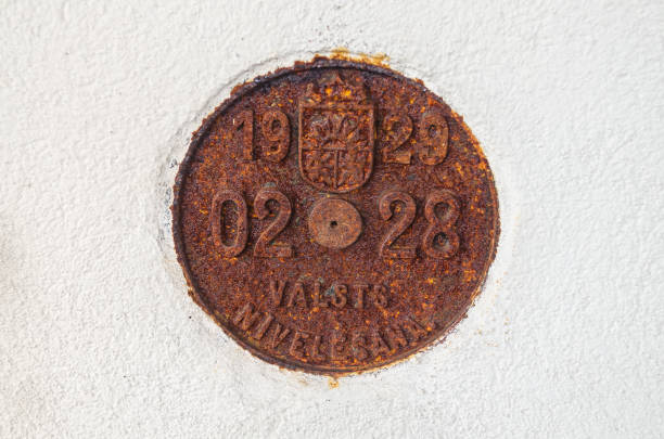 istock Kuldiga, Latvia - July 13, 2017: Geodetic mark (sign) on the white wall (1929). 1371593119