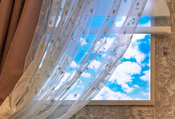 istock Curtan and transparent tulle on the window with clouds. 1371593395
