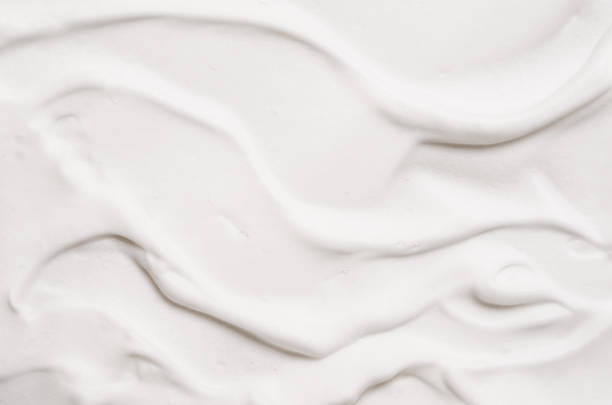 istock Mousse cleanser soft white foam soap texture background. 1371596678