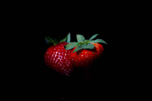 istock Strawberry against a black background 1371597137