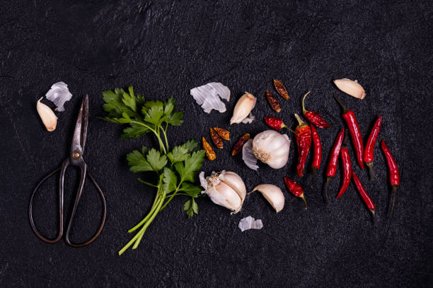 Vegetables cut into pieces: (cucumber, tomato and pepper) and herbs (parsley and dill) on a cutting board in the kitchen