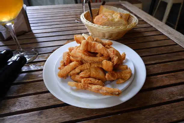 Fried squid with bread in a table in a restaurant