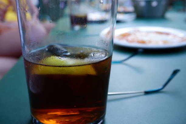 istock Half glass with coke, ice and lemon 1371609224