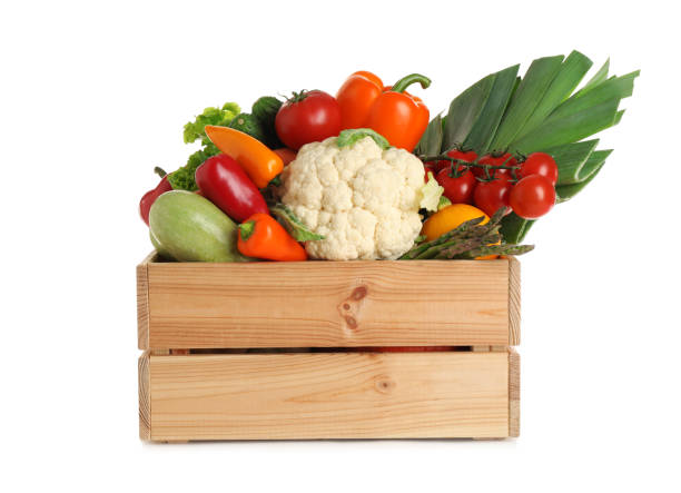 istock Wooden crate with fresh vegetables on white background 1371609336