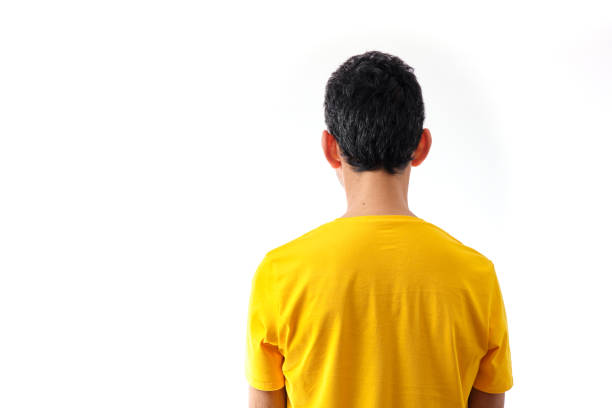 istock brunette man with yellow t-shirt from behind on white background 1371614599