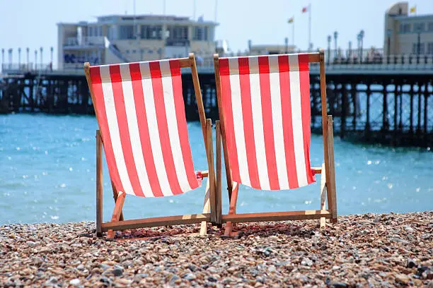 Red and white striped deck chairs on Worthing beach