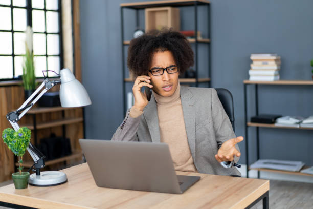 istock Serious businessman using his cellphone 1371620502