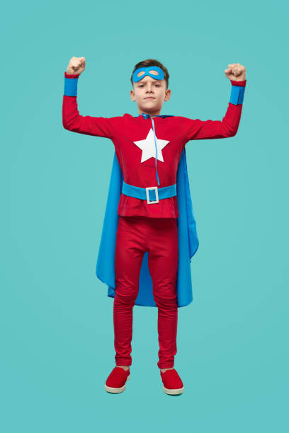 istock Strong superhero child showing power in studio 1371620648