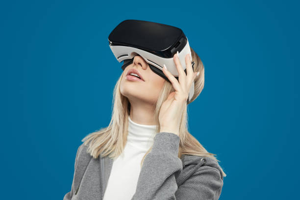 istock Woman exploring virtual reality in VR headset 1371620669