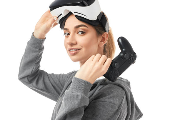 istock Young woman with gamepad and VR helmet 1371620679