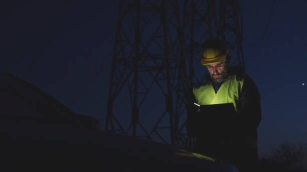 istock High voltage engineer working on the field at night. Sustainable energy. 1371621315