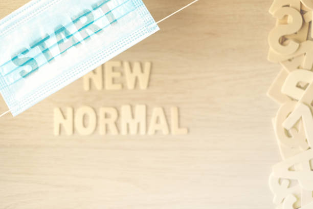 istock The word START on the mask, Rustic background the word NEW NORMAL. 1371622153