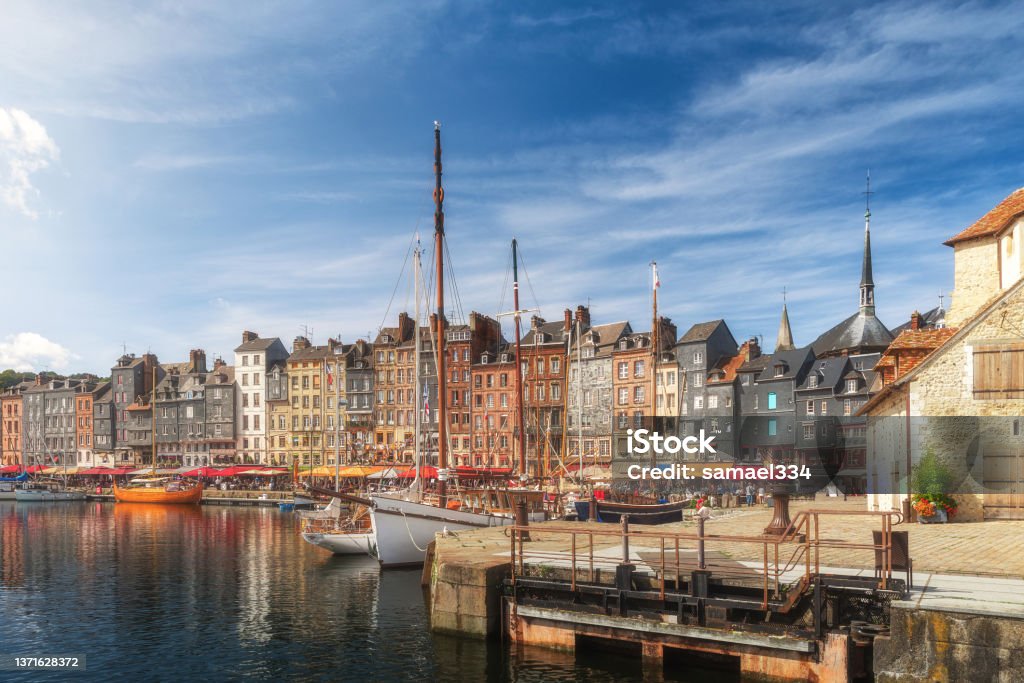 The harbor of Honfleur port, Normandy, France with colorful buildings, boats and yachts The harbor of Honfleur port, Normandy, France with colorful buildings, boats and yachts. Popular french town Normandy Stock Photo