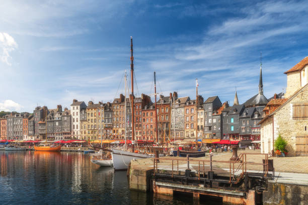 the harbor of honfleur port, normandy, france with colorful buildings, boats and yachts - normandiya stok fotoğraflar ve resimler