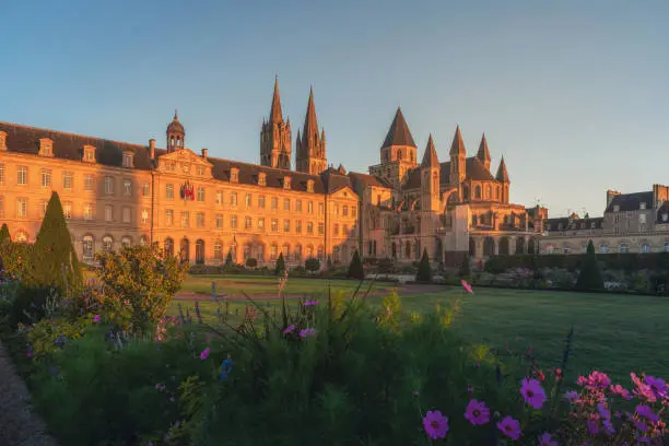 Caen, Normandy, France. Beautiful Abbey of Saint-Etienne or Abbaye aux Hommes and city hall at sunrise. former monastery. Popular tourist destination