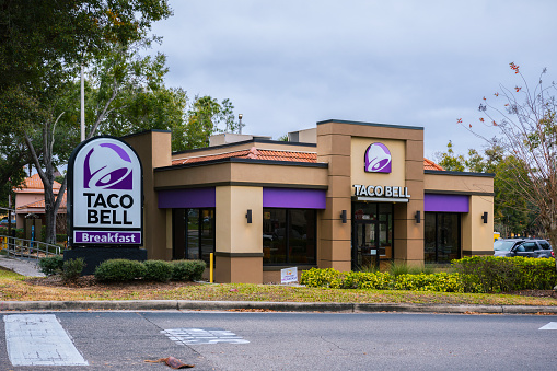 Orlando, Florida - February 6, 2022: Horizontal Wide View of Taco Bell Restaurant Building Exterior.