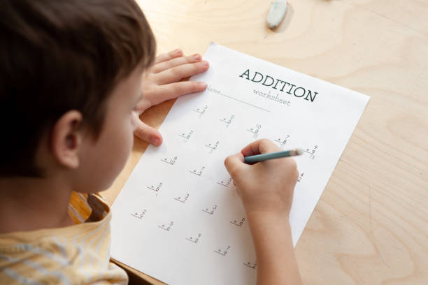 istock A schoolboy doing math lesson sitting at desk in the children room 1371640554