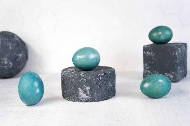 istock Blue Easter eggs on grey podium or pedestal. Natural coloring Easter eggs with red cabbage in blue color 1371643971